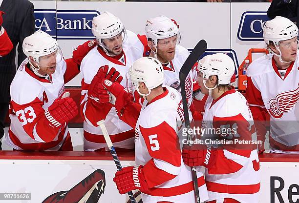 Kris Draper, Drew Miller and Daniel Cleary of the Detroit Red Wings congratulate Nicklas Lidstrom after he scored a second period goal against the...