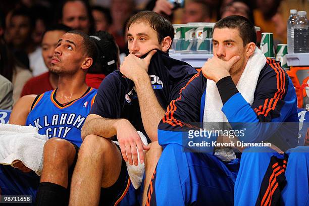 Thabo Sefolosha, Nenad Krstic and Nick Collison of the Oklahoma City Thunder sit on the bench in the second half while taking on the Los Angeles...