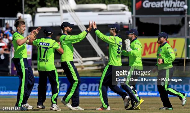 Ireland's George Dockrell celebrates with team mates after catching Virat Kohli of India during the Second International Twenty20 Match at Malahide,...