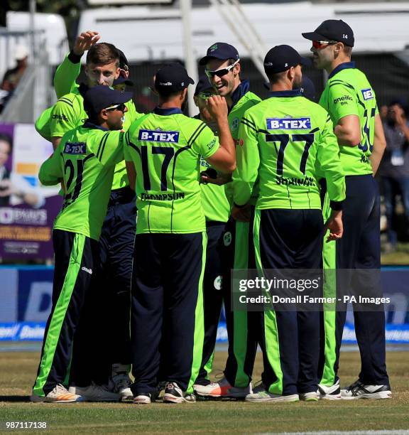 Ireland's George Dockrell celebrates with team mates after catching Virat Kohli of India during the Second International Twenty20 Match at Malahide,...