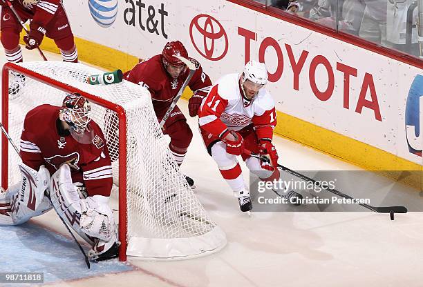 Daniel Cleary of the Detroit Red Wings skates with the puck past goaltender Ilya Bryzgalov of the Phoenix Coyotes in Game Seven of the Western...