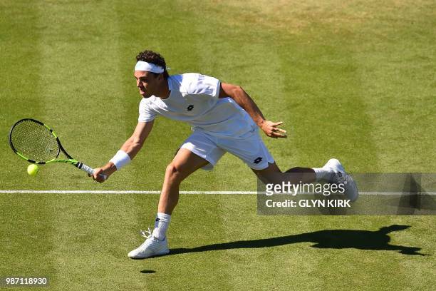 Italy's Marco Cecchinato returns to Slovakia's Lukas Lacko during their men's singles semi-final match at the ATP Nature Valley International tennis...