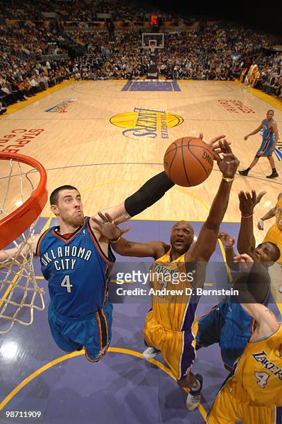 Nick Collison of the Oklahoma City Thunder and Lamar Odom of the Los Angeles Lakers reach for a rebound in Game Five of the Western Conference...