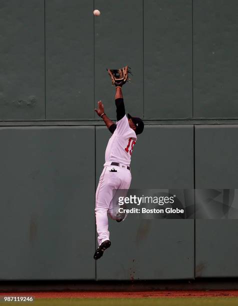 Boston Red Sox center fielder Jackie Bradley Jr. Leaps to make the catch on a deep drive to center field by Los Angeles Angels left fielder Justin...
