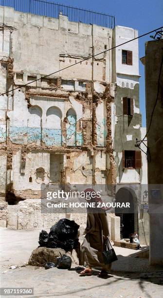 Woman walks in a street of the kasbah quarter in Algiers, 26 June 2002. Centuries of history in the ancient Algiers kasbah are failing away. Once a...