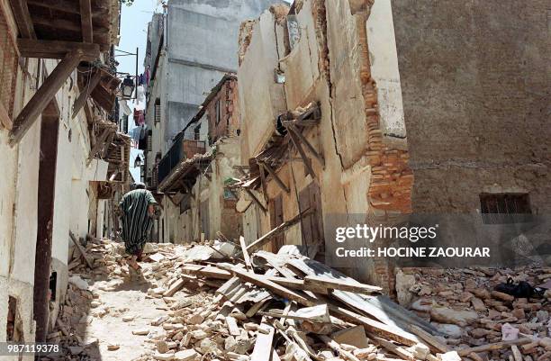 Man walks up a street of the Kasbah quarter in Algiers, 26 June 2002. Centuries of history in the ancient Algiers Kasbah are falling away, literally....