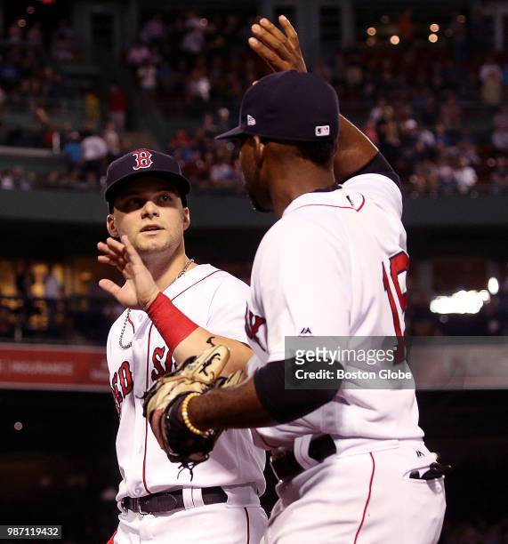 Boston Red Sox center fielder Jackie Bradley Jr. Congratulates Boston Red Sox left fielder Andrew Benintendi on his catch during the eighth inning....