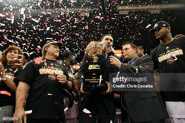 Dan Reed, president of the NBA D-League, presents the championship trophy to Alonzo Cantu, owner of the Rio Grande Valley Vipers, after his team...