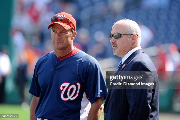 Manager Jim Riggleman and Senior Vice President and General Manager Mike Rizzo of the Washington Nationals talk on the field prior to a game on April...