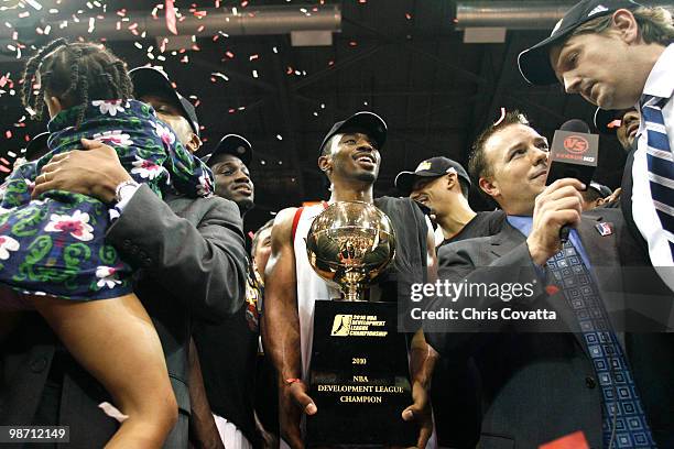 Michael Harris of the Rio Grande Valley Vipers holds the D-League championship trophy while head coach Chris Finch is interviewed. The Rio Grande...