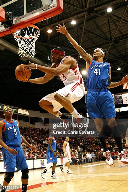 Stanley Asumnu of the Rio Grande Valley Vipers shoots from behind the basket while being defended by Deron Washington of the Tulsa 66ers in Game Two...