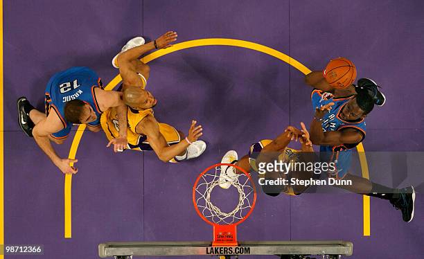 Jeff Green of the Oklahoma City Thunder shoots over Andrew Bynun of the Los Angeles Lakers as Laker Derek Fisher and Nenad Krstic of the Thunder...