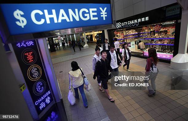 HongKong-China-US-economy-currency-trading-finance,FOCUS by Peter Brieger People walk past a currency exchange shop in the Causeway Bay area of Hong...