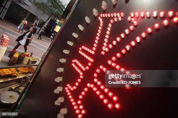HongKong-China-US-economy-currency-trading-finance,FOCUS by Peter Brieger People walk down a street past a Chinese yuan sign at a currency exchange...