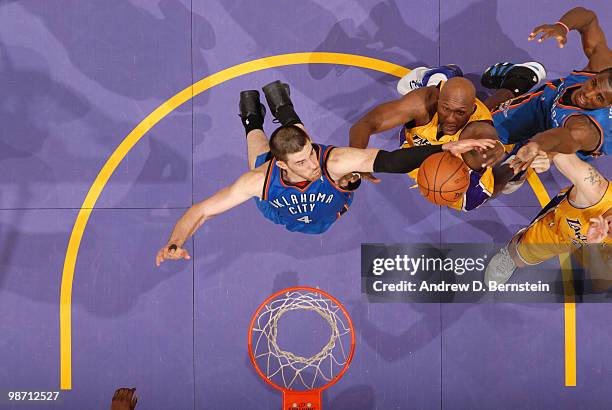 Nick Collison of the Oklahoma City Thunder reaches for a rebound against Lamar Odom of the Los Angeles Lakers in Game Five of the Western Conference...