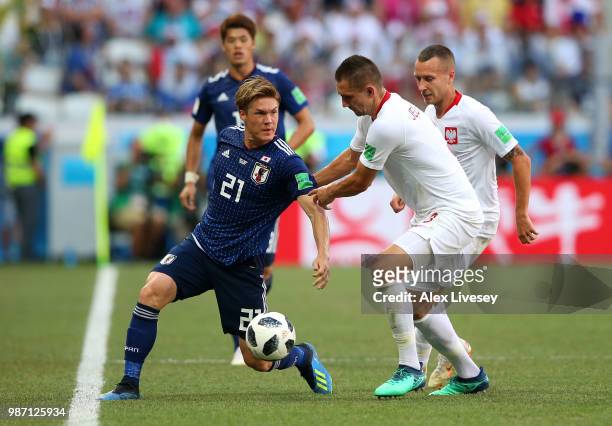Gotoku Sakai of Japan is challenged by Artur Jedrzejczyk of Poland during the 2018 FIFA World Cup Russia group H match between Japan and Poland at...