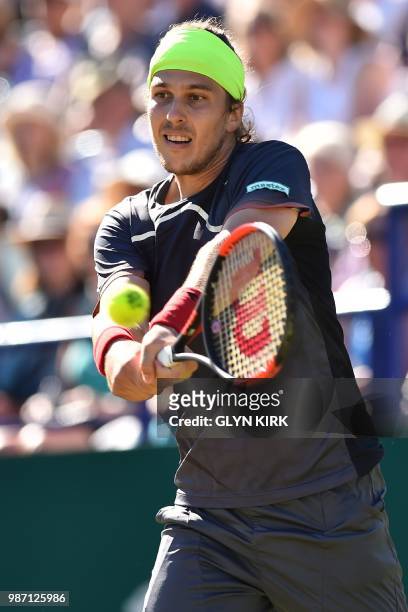 Slovakia's Lukas Lacko returns to Italy's Marco Cecchinato during their men's singles semi-final match at the ATP Nature Valley International tennis...