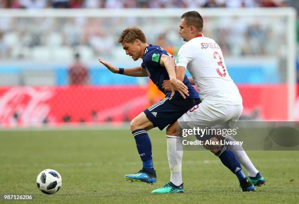 Gotoku Sakai of Japan is challenged by Artur Jedrzejczyk of Poland during the 2018 FIFA World Cup Russia group H match between Japan and Poland at...