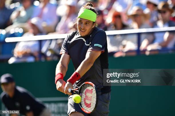 Slovakia's Lukas Lacko returns to Italy's Marco Cecchinato during their men's singles semi-final match at the ATP Nature Valley International tennis...