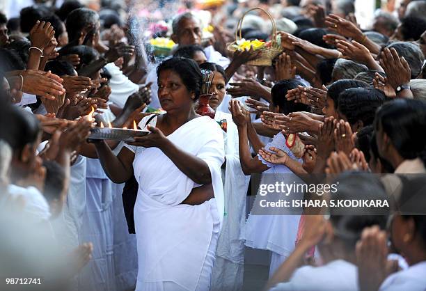 Sri Lankan Buddhists pray on the Poya full moon at the Kelaniya Temple on April 28, 2010. The predominantly Buddhist country marks every full moon as...