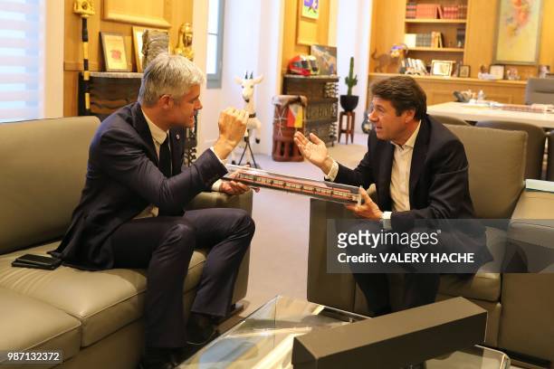 Mayor of Nice Christian Estrosi gives a scale of Nice tramway to President of Les Republicains right-wing party Laurent Wauquiez at the city hall of...