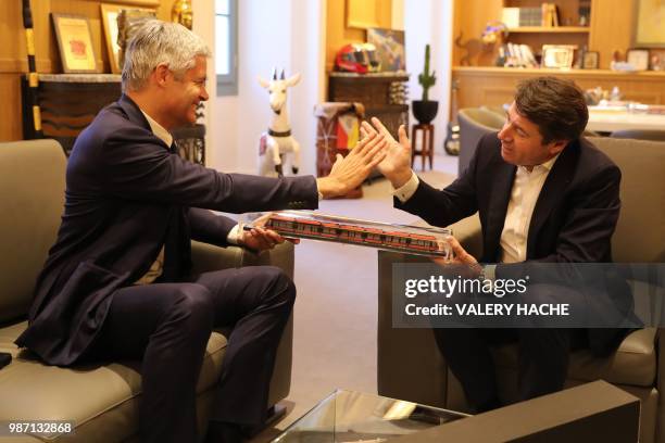 Mayor of Nice Christian Estrosi gives a scale of Nice tramway to President of Les Republicains right-wing party Laurent Wauquiez at the city hall of...