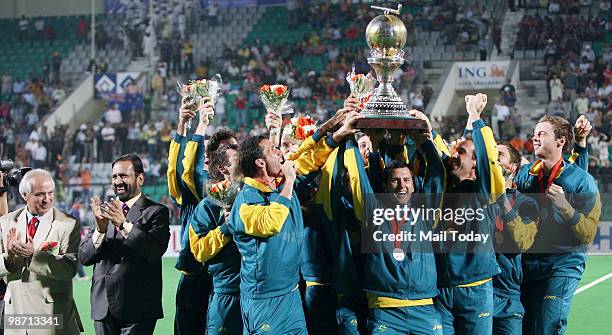 The Australian team pose with the trophy during the International Hockey Federation World Cup 2010 field hockey match in New Delhi on Saturday, March...