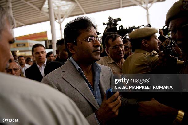 Suspended Indian Premier League Chairman Lalit Modi arrives at Indira Gandhi International Airport's domestic terminal in New Delhi on April 28,...