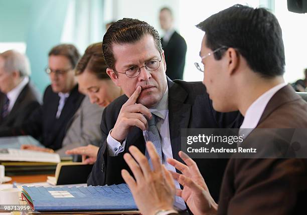 German Defense Minister Karl-Theodor zu Guttenberg chats with German Health Minister Philipp Roesler prior to the weekly German government cabinet...