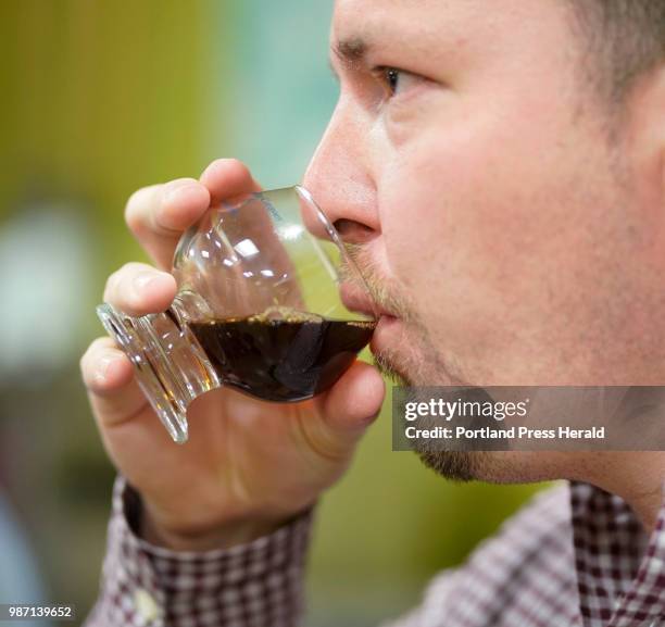 Benkei O'Sullivan, general manager of Bolster, Snow and Co. Tastes a coffee blend while working with the staff at Coffee by Design on Thursday, June...