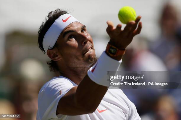 Rafael Nadal of Spain serves to Lucas Pouille of France during day four of the Aspall Classic at the Hurlingham Club, London.