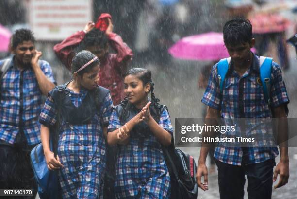 School children get drenched in rain at Bhandup, on June 28, 2018 in Mumbai, India. Heavy rains made a comeback in Mumbai causing waterlogging in...