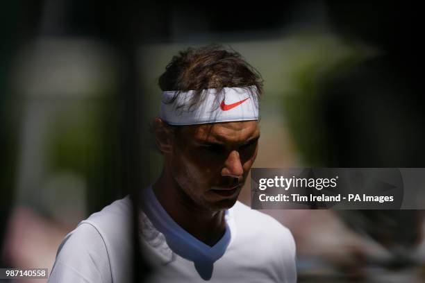 Rafael Nadal of Spain walks back to his chair during his match with Lucas Pouille of France during day four of the Aspall Classic at the Hurlingham...