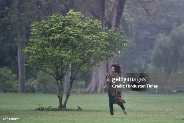 Girl enjoys in the rain at Lodhi Gardens, on June 29, 2018 in New Delhi, India. Delhi enjoyed its first monsoon showers on Thursday, with 20.4 mm...