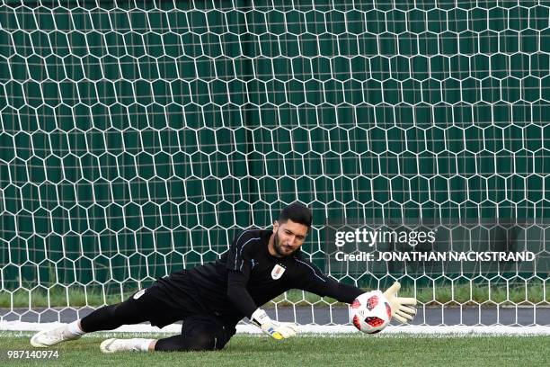 Uruguay's goalkeeper Martin Campana jumps to catch the ball as he takes part in a training session of Uruguay's national football team at the Park...