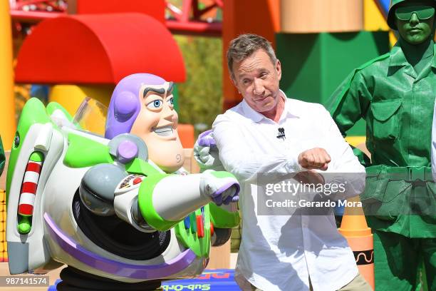 Actor Tim Allen and Disney character Buzz Lightyear pose "The Toy Story Land" preview at Disney's Hollywood Studios on June 29, 2018 in Orlando,...