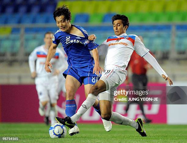 Song Chong-Gug of South Korea's Suwon Bluewings fights for the ball with Rhysh Roshan Rai of Singapore's Armed Forces FC during a Group G football...