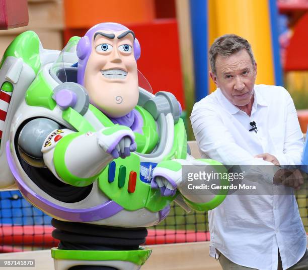 Actor Tim Allen and Disney character Buzz Lightyear pose "The Toy Story Land" preview at Disney's Hollywood Studios on June 29, 2018 in Orlando,...