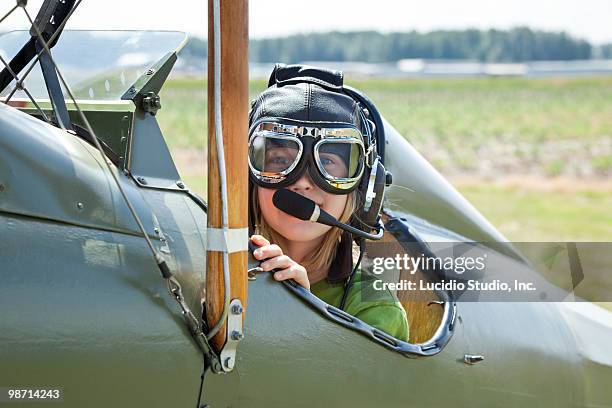 girl sitting in an open cockpit biplane - biplane stock pictures, royalty-free photos & images