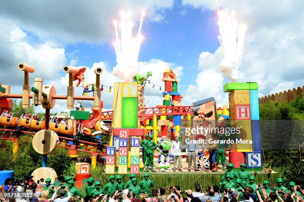 Actor Tim Allen and Disney Parks Chairman Robert A. Chapek pose with Disney characters during "The Toy Story Land" grand opening at Disney's...