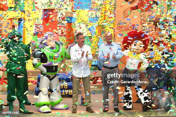 Actor Tim Allen and Disney Parks Chairman Robert A. Chapek pose with Disney characters during "The Toy Story Land" grand opening at Disney's...