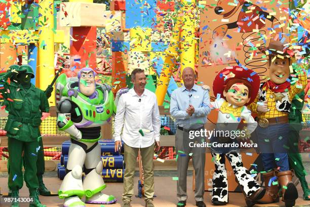 Actor Tim Allen and Disney Parks Chairman Robert A. Chapek pose with Disney characters during "The Toy Story Land" grand opening at Disney's...