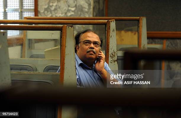 Pakistani stockbroker watches the latest share prices on a screen during a trading session at the Karachi Stock Exchange on April 28, 2010. The...