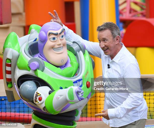 Actor Tim Allen and Disney character Buzz Lightyear pose during "The Toy Story Land" grand opening at Disney's Hollywood Studios on June 29, 2018 in...