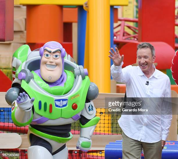 Actor Tim Allen and Disney character Buzz Lightyear pose during "The Toy Story Land" grand opening at Disney's Hollywood Studios on June 29, 2018 in...