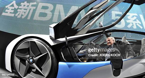 Bavarian Prime Minister Horst Seehofer gets off a "Vision" hybrid concept car by German car maker BMW as he visits the Auto China motor show on April...