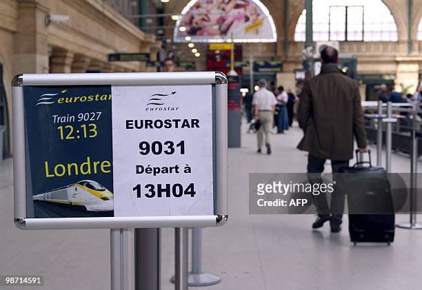 Passenger passes by an information board in Paris gare du Nord railway station, on April 20 to embark aboard a Eurostar train to London. France...