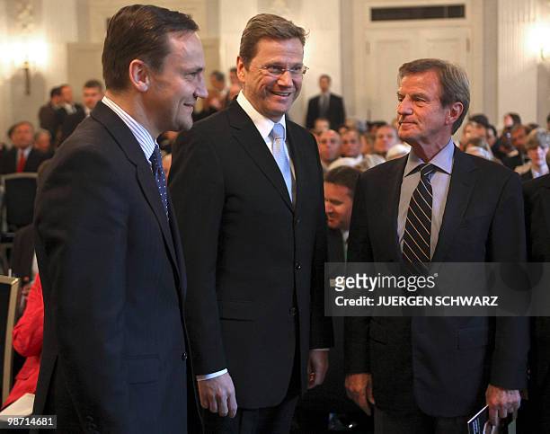 German Foreign Minister and vice-chancellor Guido Westerwelle stands in between Polish Foreign Minister Radoslaw Sikorski and French Foreign Minister...
