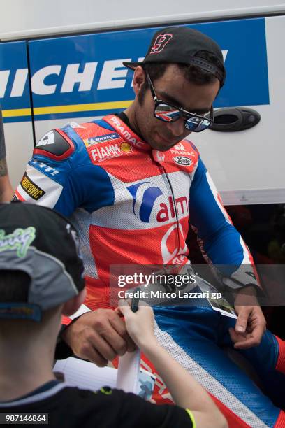 Danilo Petrucci of Italy and Alma Pramac Racing signs autographs for fan in paddock during the MotoGP Netherlands - Free Practice on June 29, 2018 in...