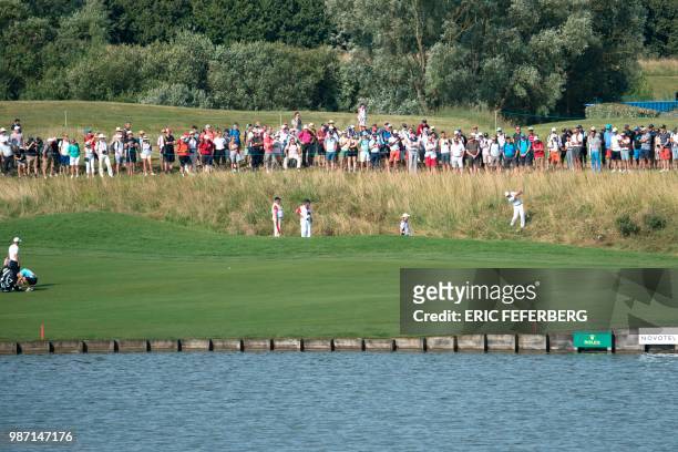 Spectators watch as Spanish golfer Sergio Garcia competes in the second round of the HNA Open de France, as part of the European Tour 2018, at the...